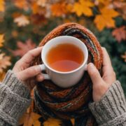 Person with scarf and tea in autumn